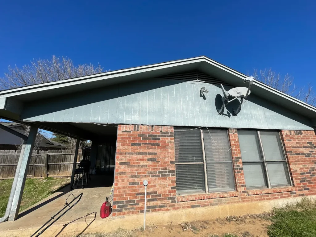 Older brick home in Grayson County Texas with deferred maintenance representative of inherited properties we buy for cash